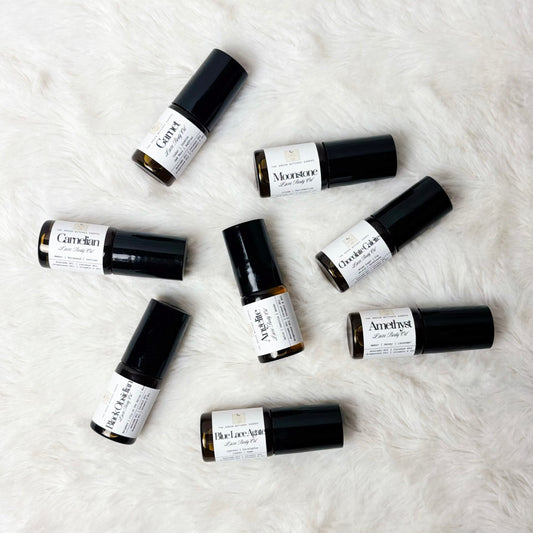 Set of small roller bottles on a textured white surface
