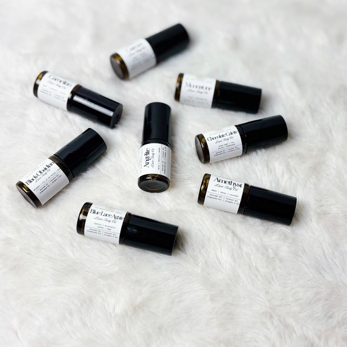 Small black and white containers on a textured white surface