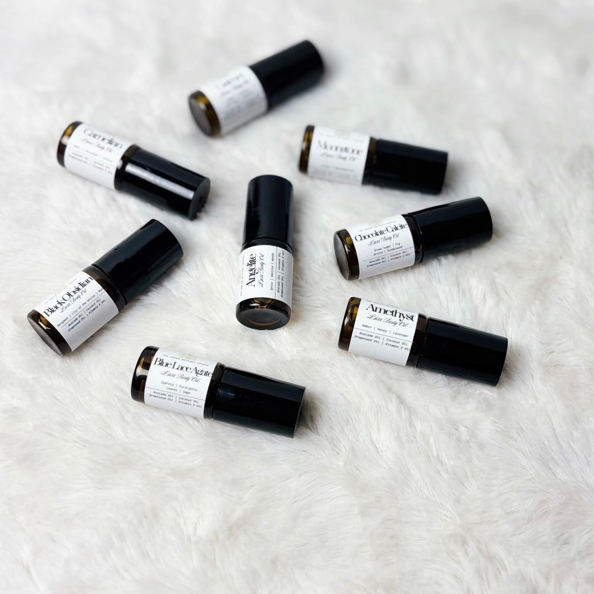 Small black and white containers on a textured white surface