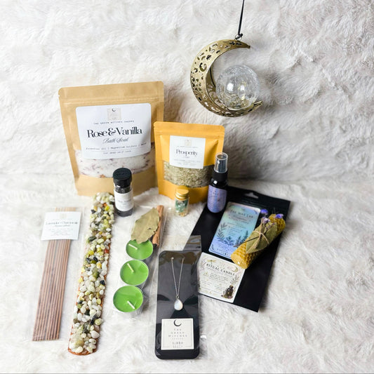 Collection of items including a necklace, bottles, and packaging on a textured white surface.