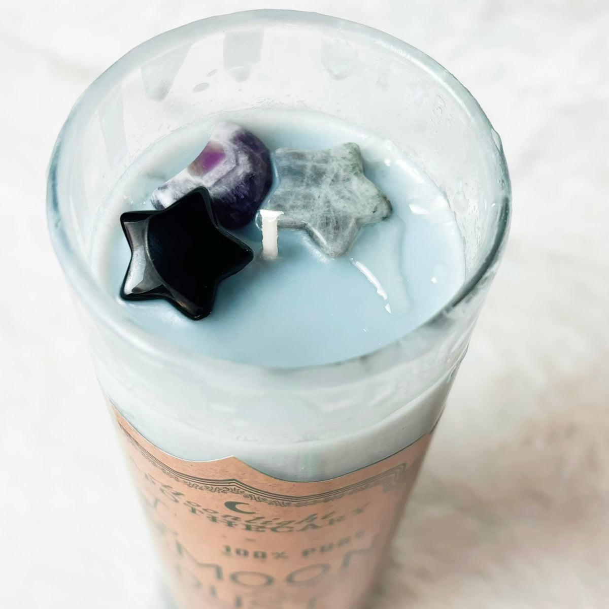 Stones on top of a candle on a white background