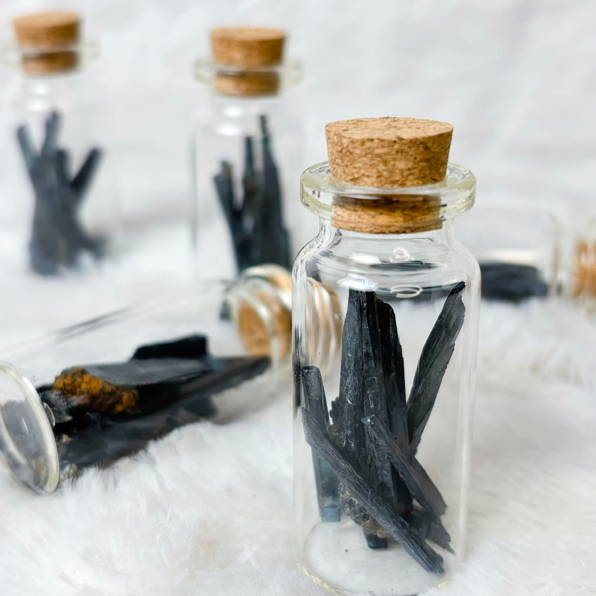 Vivianite shard jars on a white background