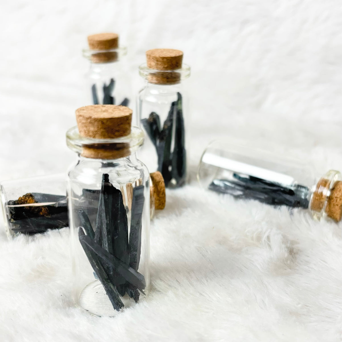Vivianite shard jars on a white background