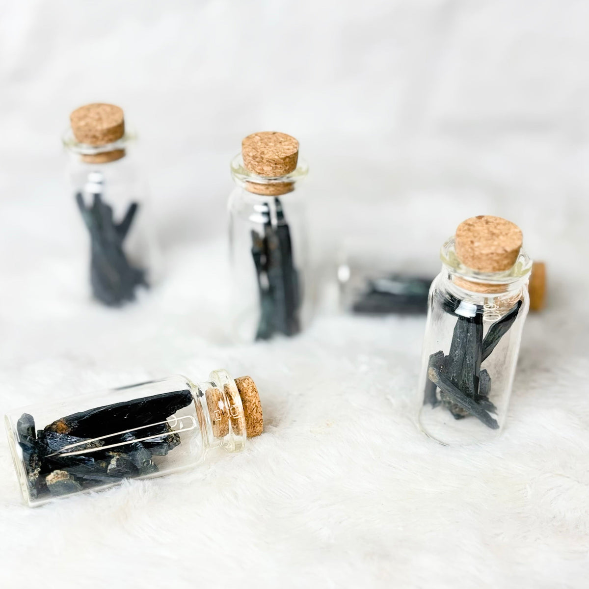 Vivianite shard jars on a white background