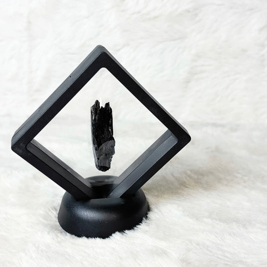 Framed Vivianite specimen on a white background