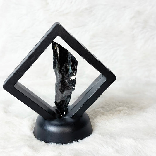 Framed Vivianite specimen on a white background