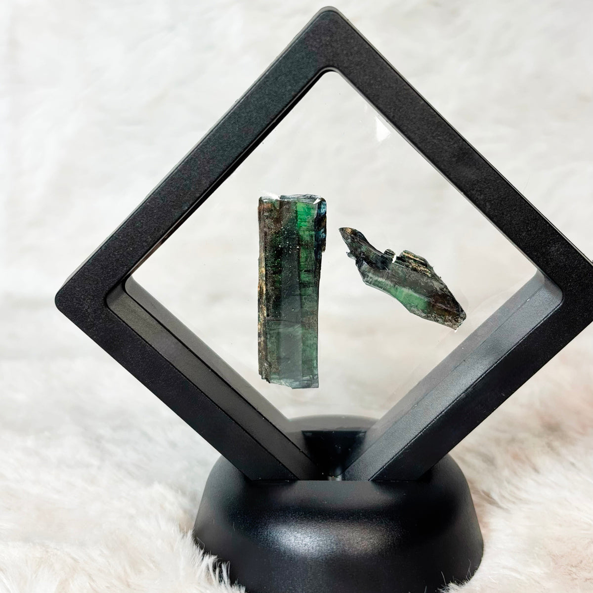 Framed Vivianite specimens on a white background