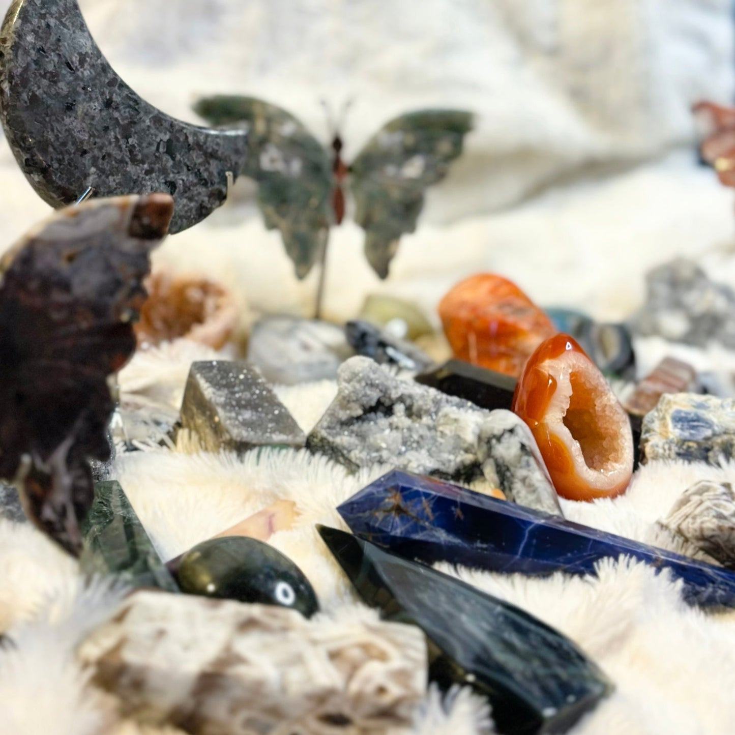 Collection of various crystals and stones on a white background